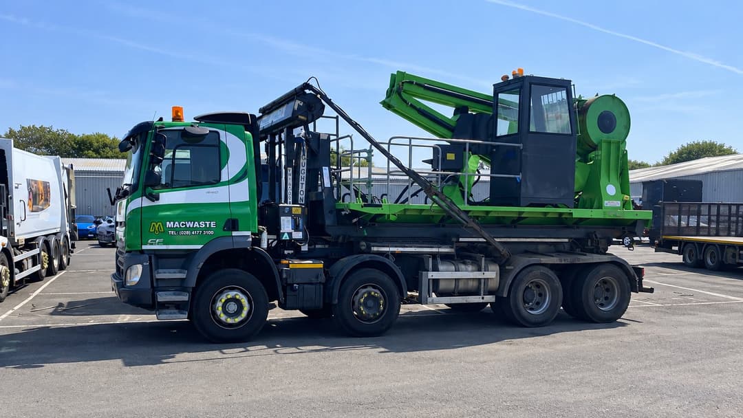 MacWaste hookloader lorry with mobile roll packer mounted on the back