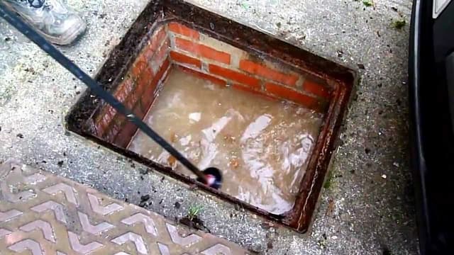 Blocked drain being cleared