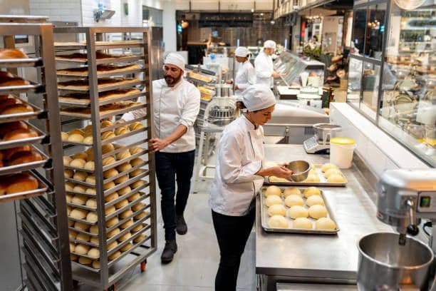 Chefs working in a commercial bakery kitchen
