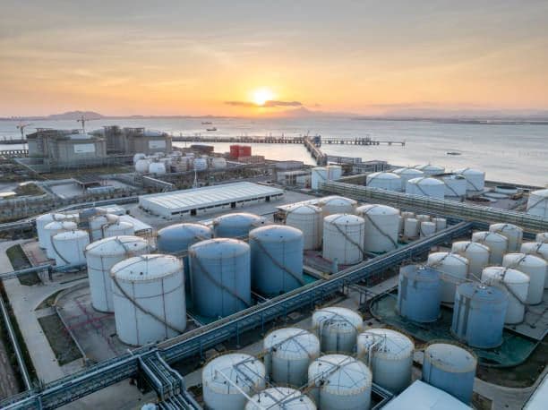 Aerial view of a bulk fuel storage terminal at sunset