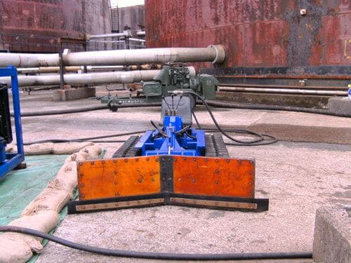Remote-controlled hydro-dozer used for large tank cleaning