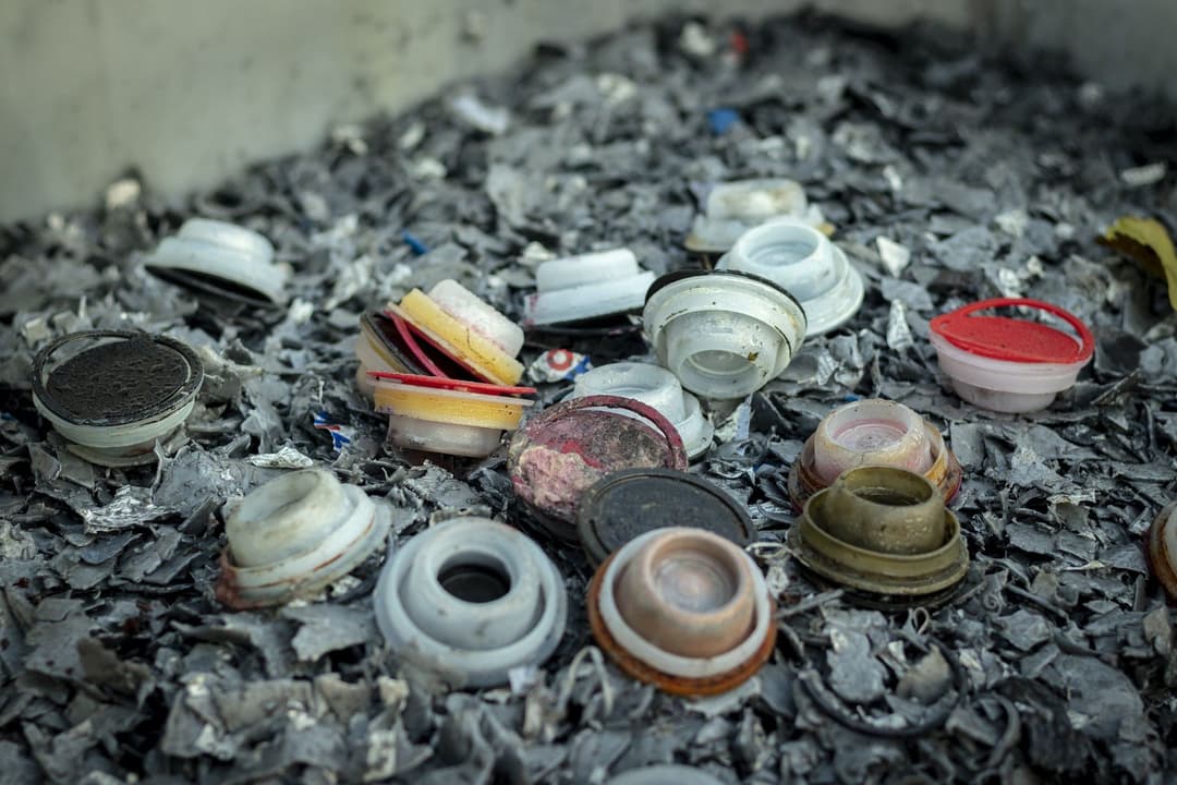 Oil-contaminated plastic containers and components collected for disposal